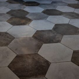 Hexagonal porcelain floor tiles in mixed grey tones