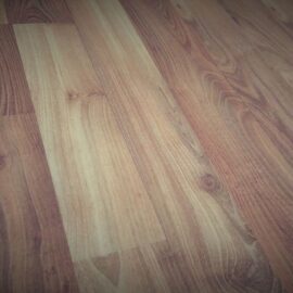 Close-up of a solid hardwood floor showing the grain running along the boards