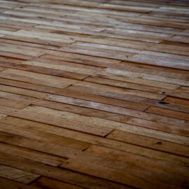 Dark vinyl plank flooring with a staggered plank pattern